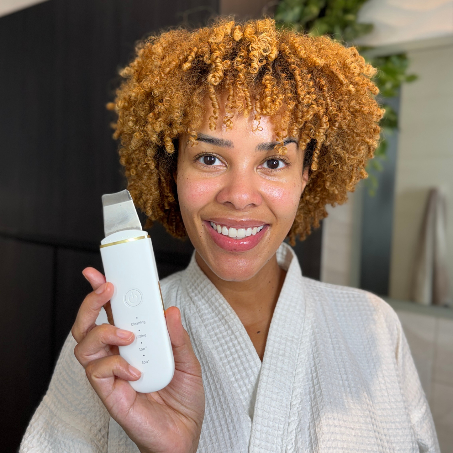 Beautiful Woman holding an Ultrasonic Skin Scrubber