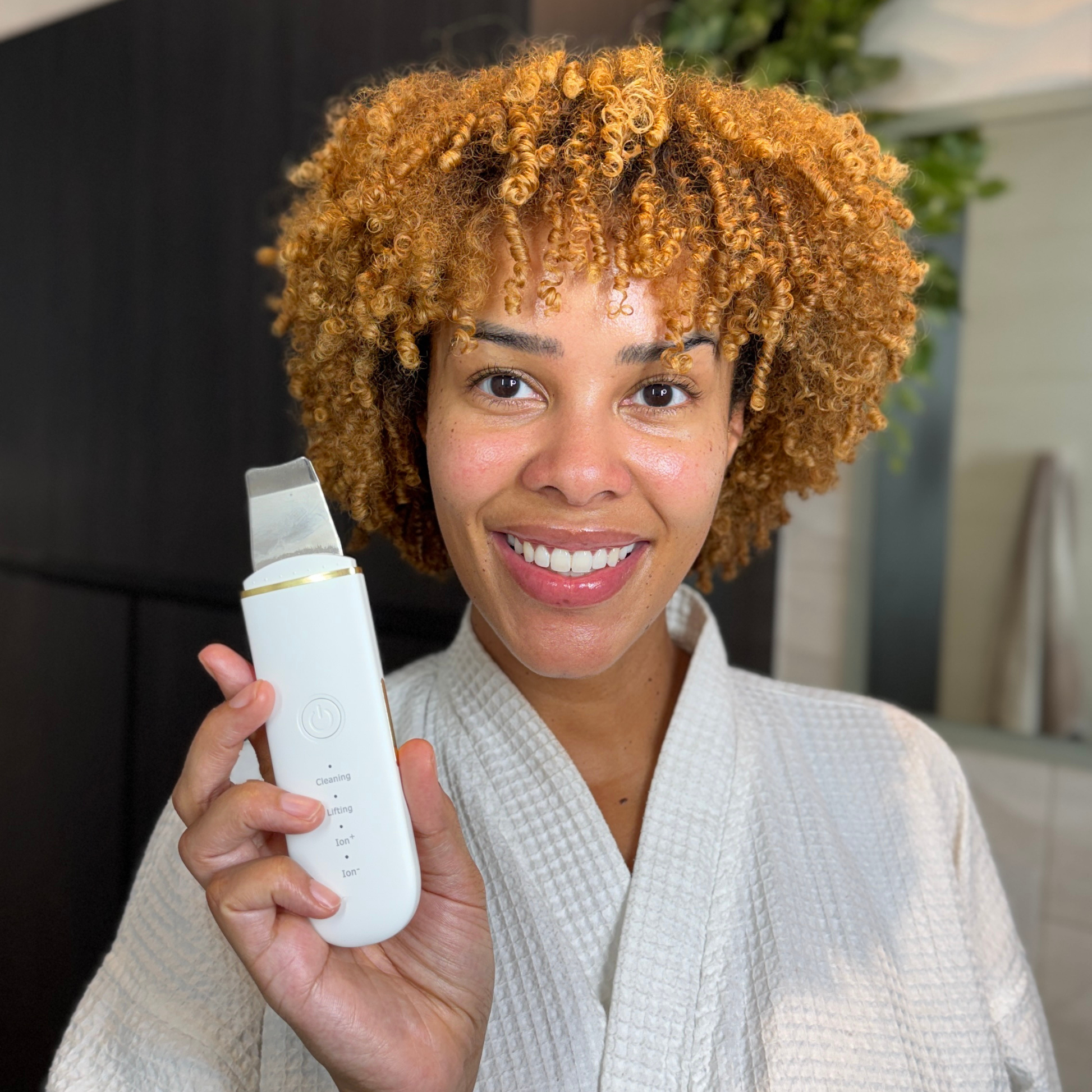 Beautiful Woman holding an Ultrasonic Skin Scrubber