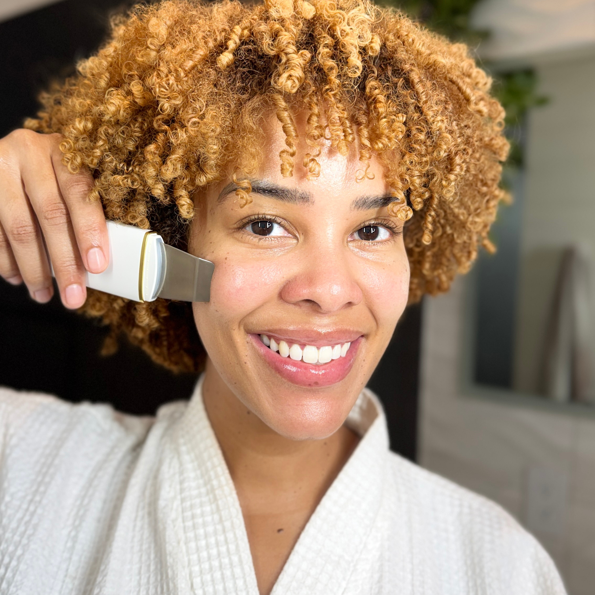 Woman with an Ultrasonic Skin Spatula