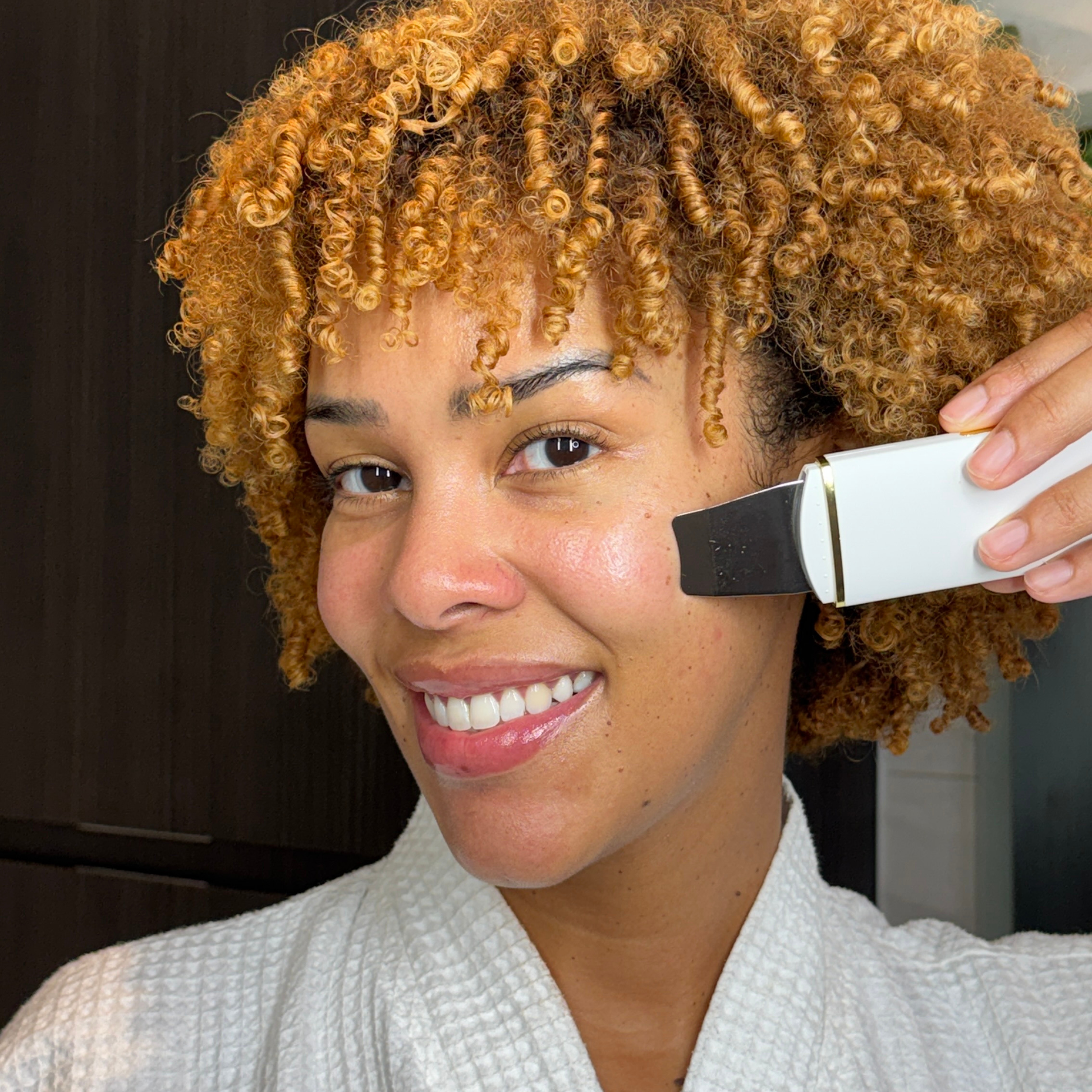 Pretty Woman with an Ultrasonic Skin Scrubber in her hands